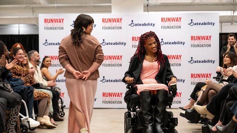 A Disabled LGBTQ+ model showcases Adaptive design at a Runway of Dreams Foundation fashion show.
