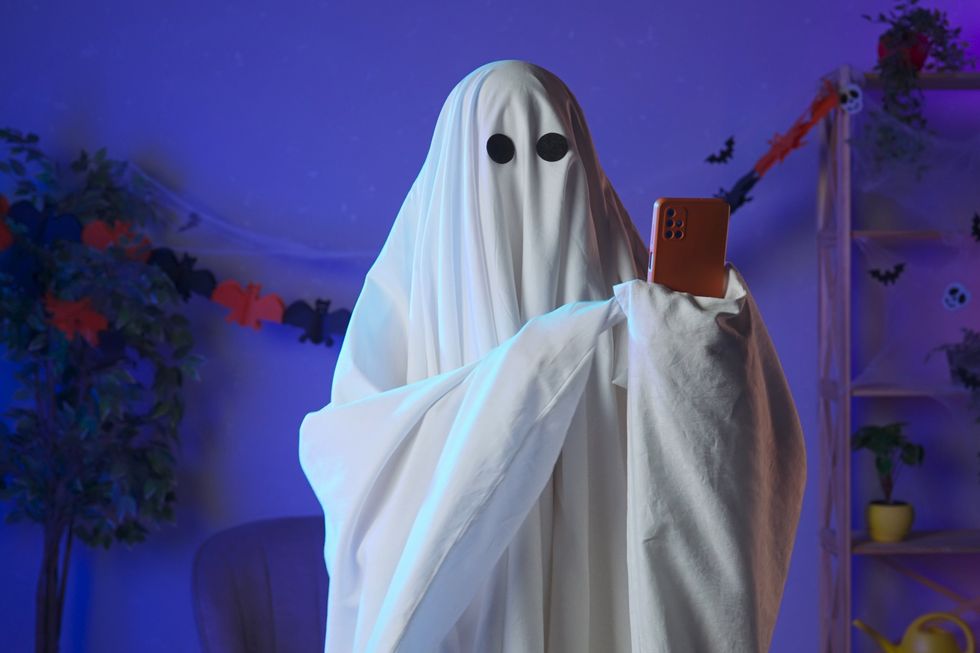 A ghost holding a cell phone