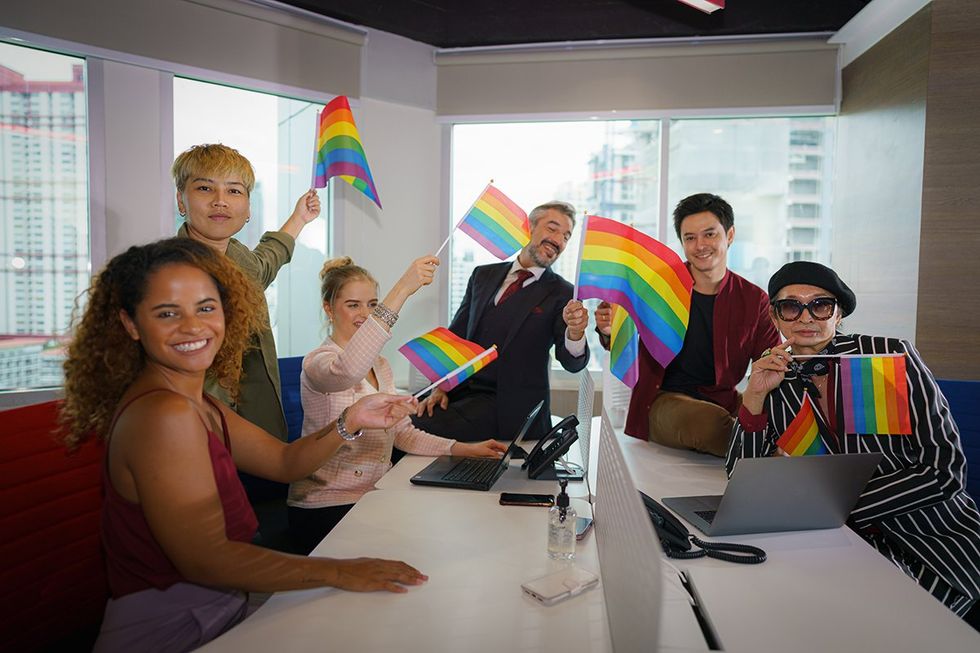 a group of people holding rainbow flags