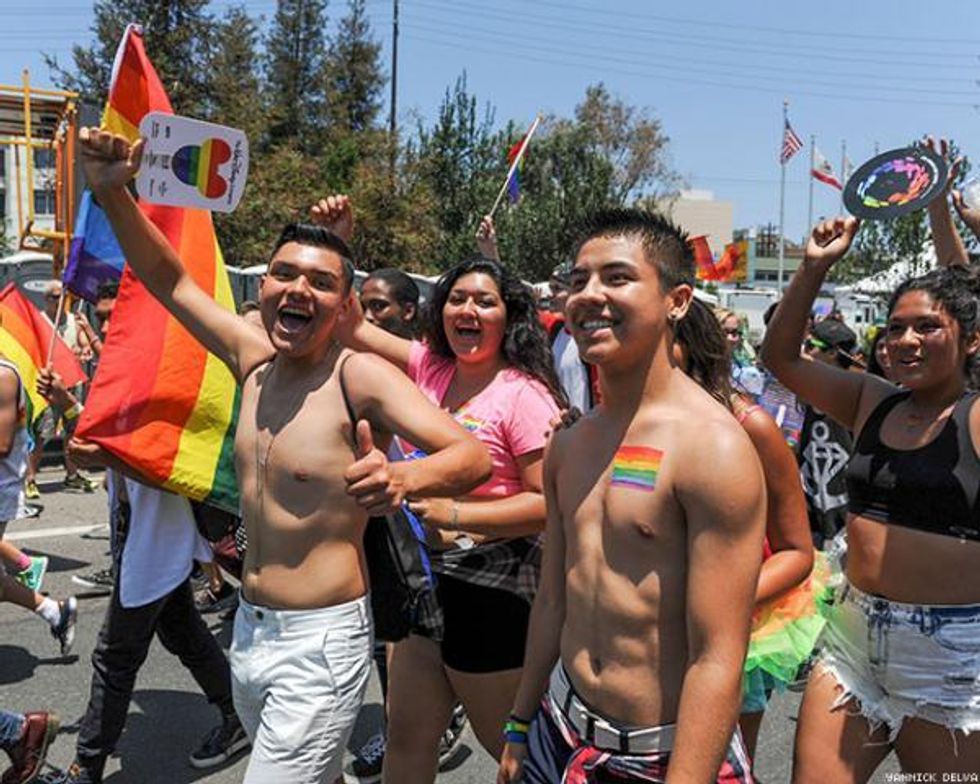 A group of people walking in the LA Pride parade. 