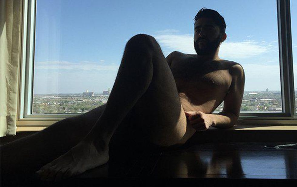 A guy laying on a ledge.