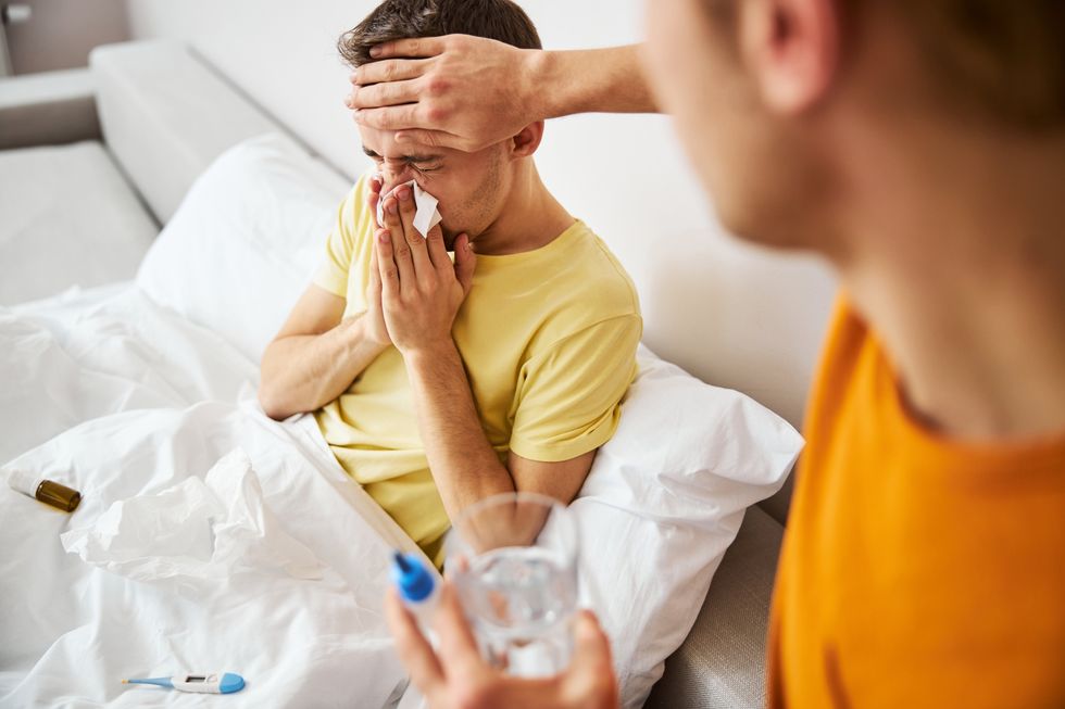 a man taking care of a sick man