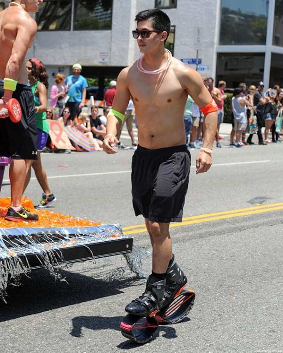 A man wearing bouncy shoes at LA Pride.