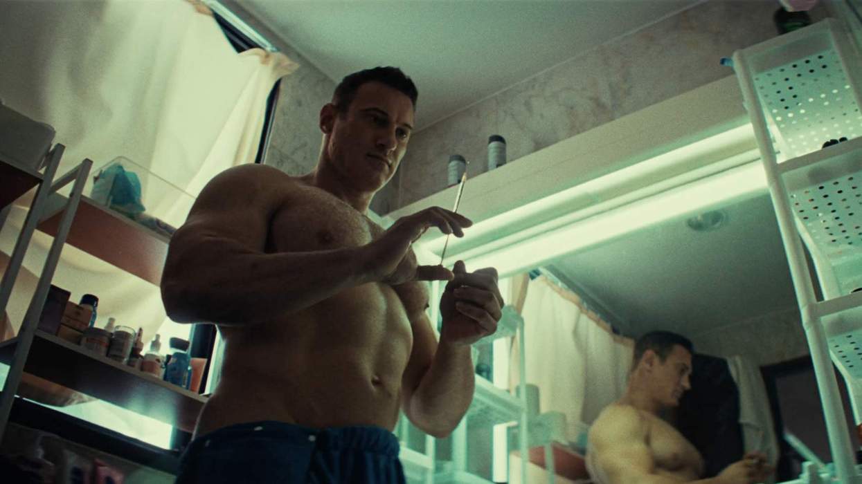 A muscular man holding a syringe