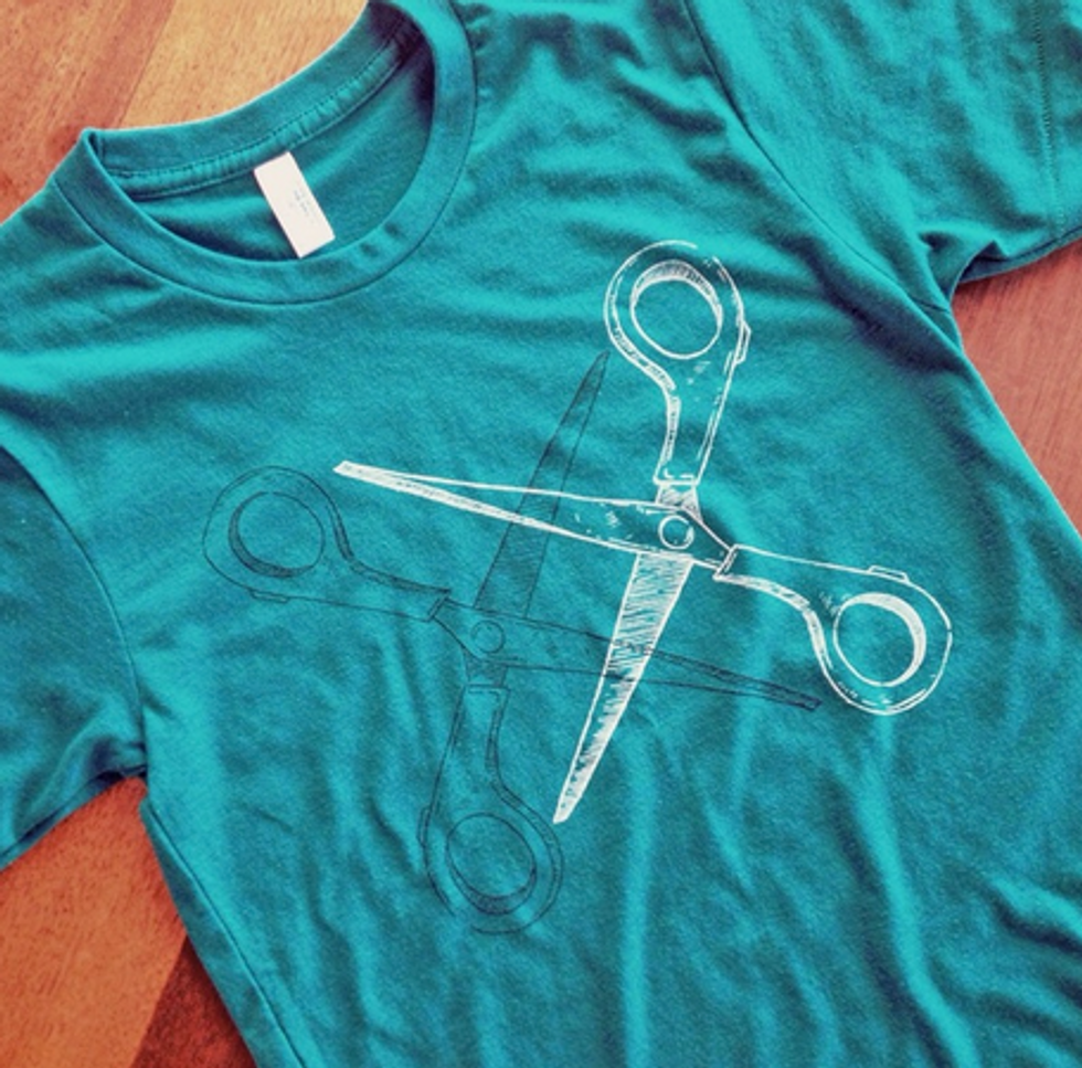 A photo of tshirt with scissors