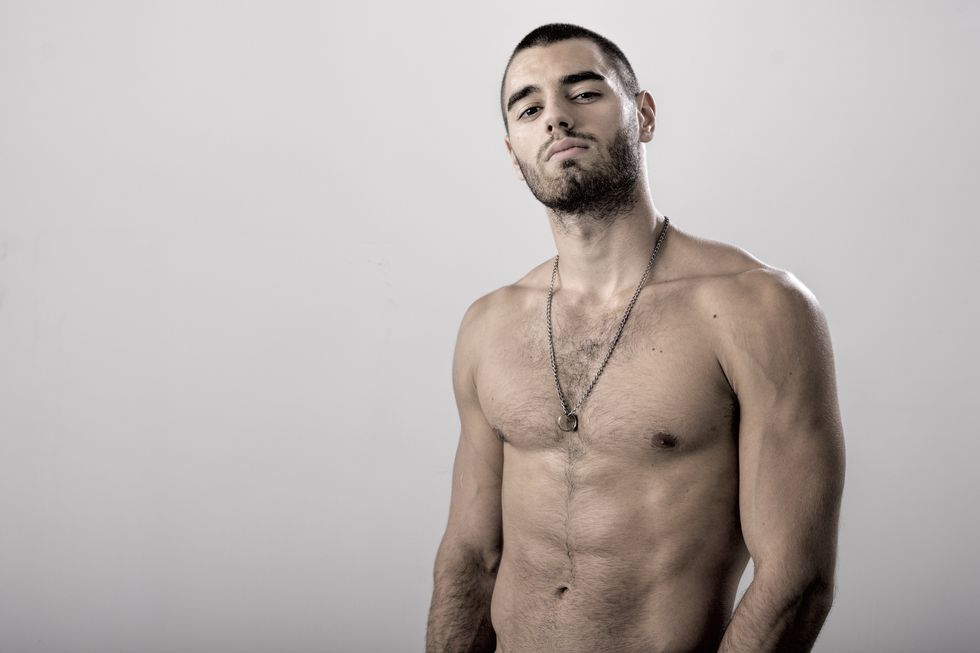a shirtless latin man