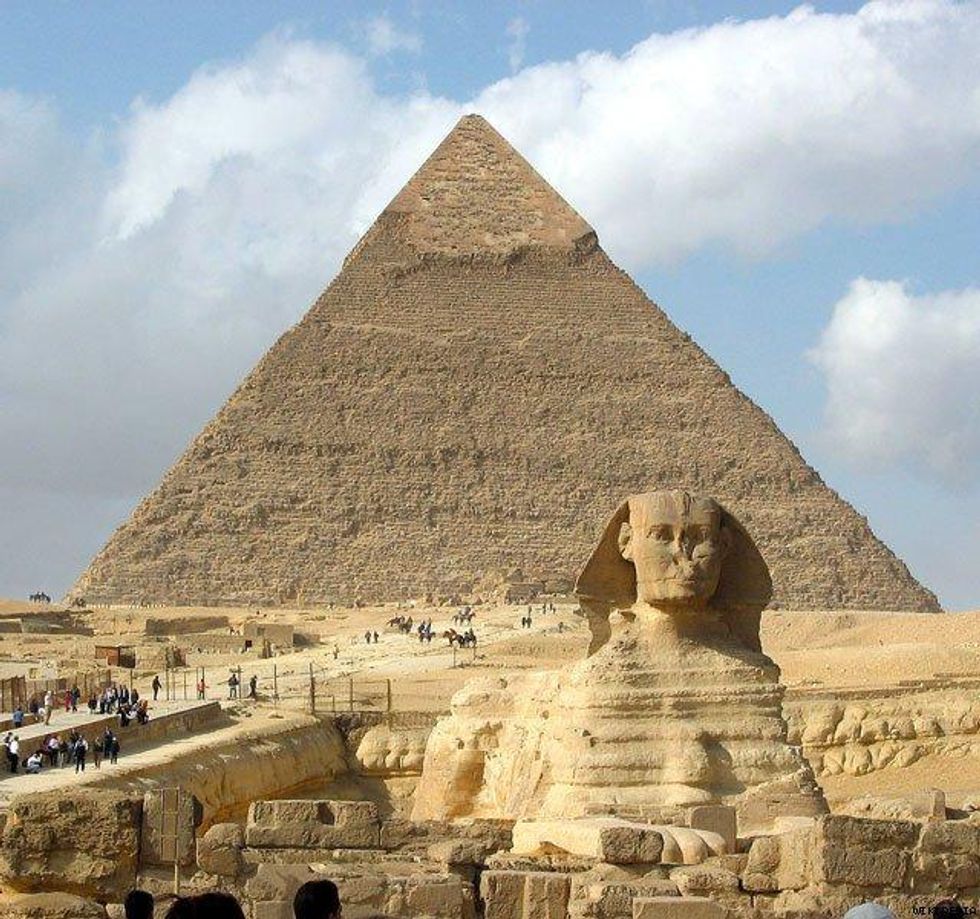 A Sphinx with a pyramid in the back