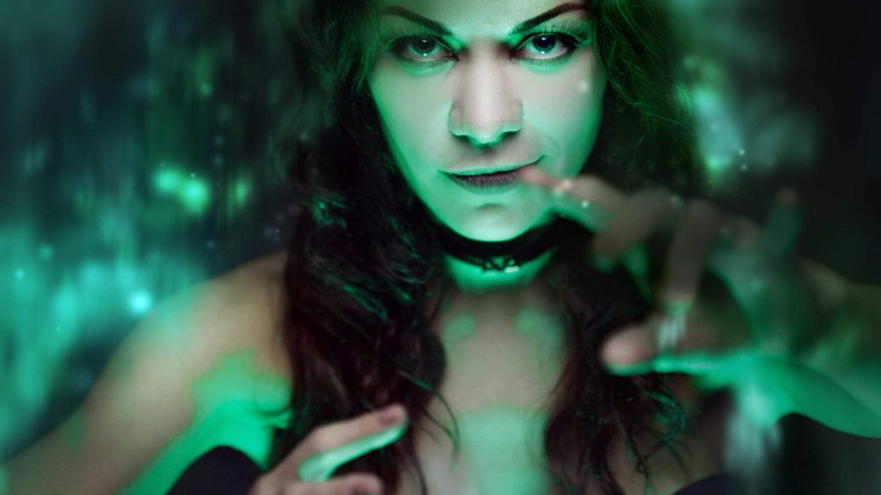 A woman looking forward with her hands out like she is doing a spell