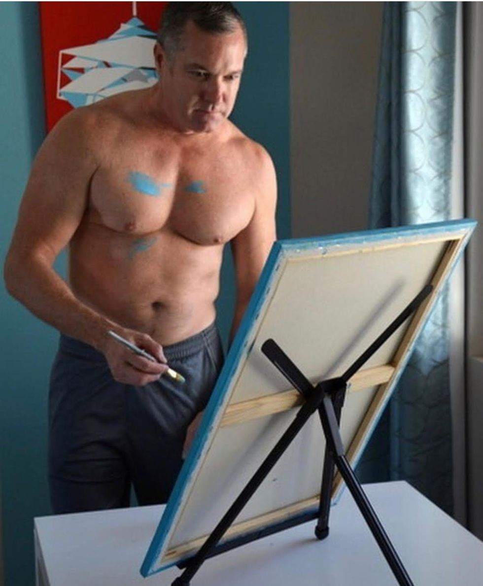 artist Chris Burbach shirtless painting