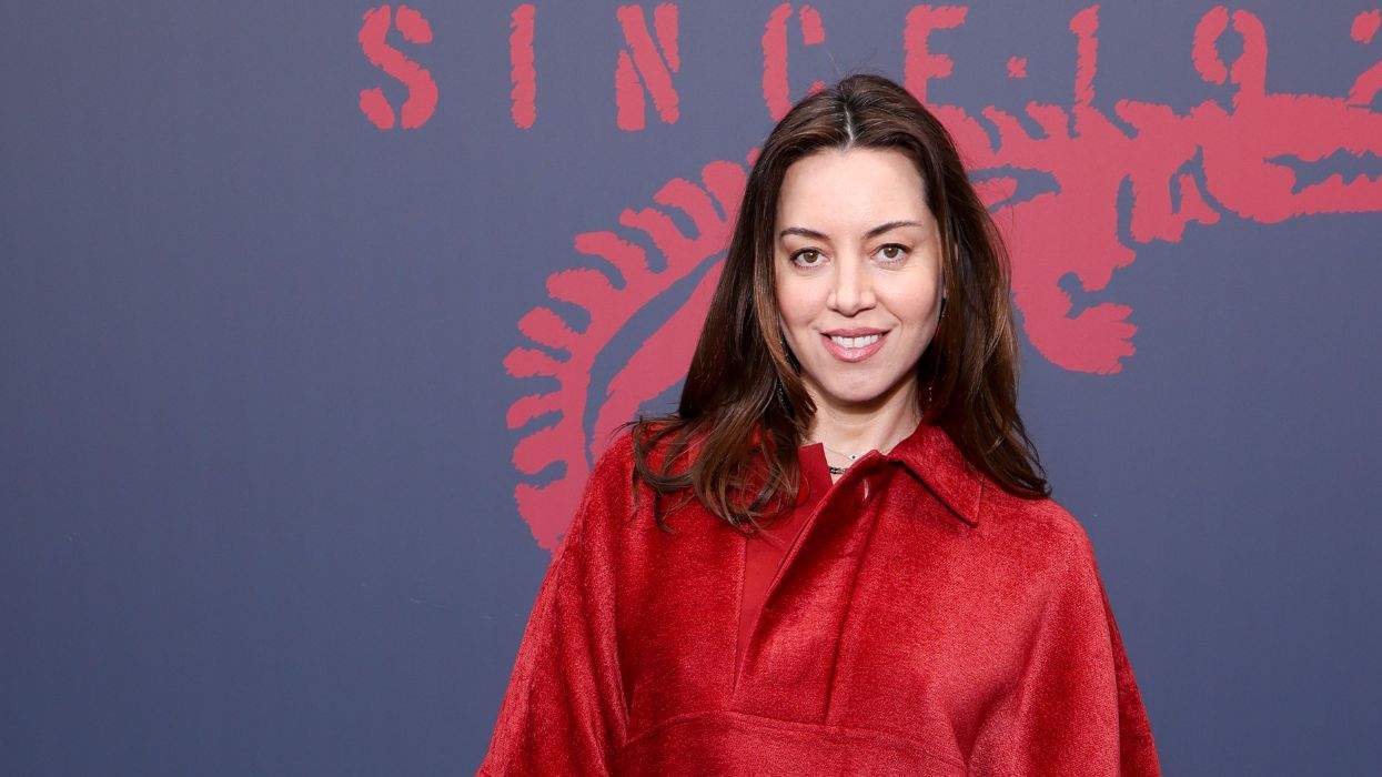Aubrey Plaza posing in red for a photo at Paris Fashion Week in March 2026