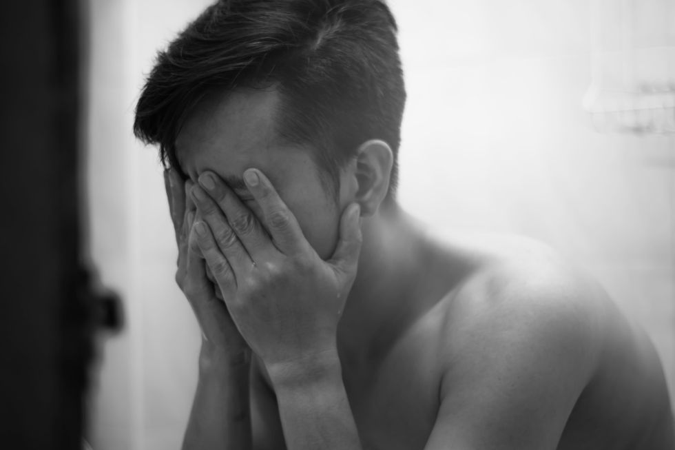 black and white photo of man who is sad
