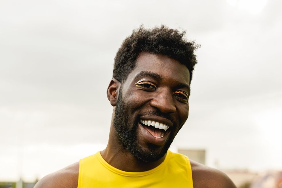 black queer man smiling