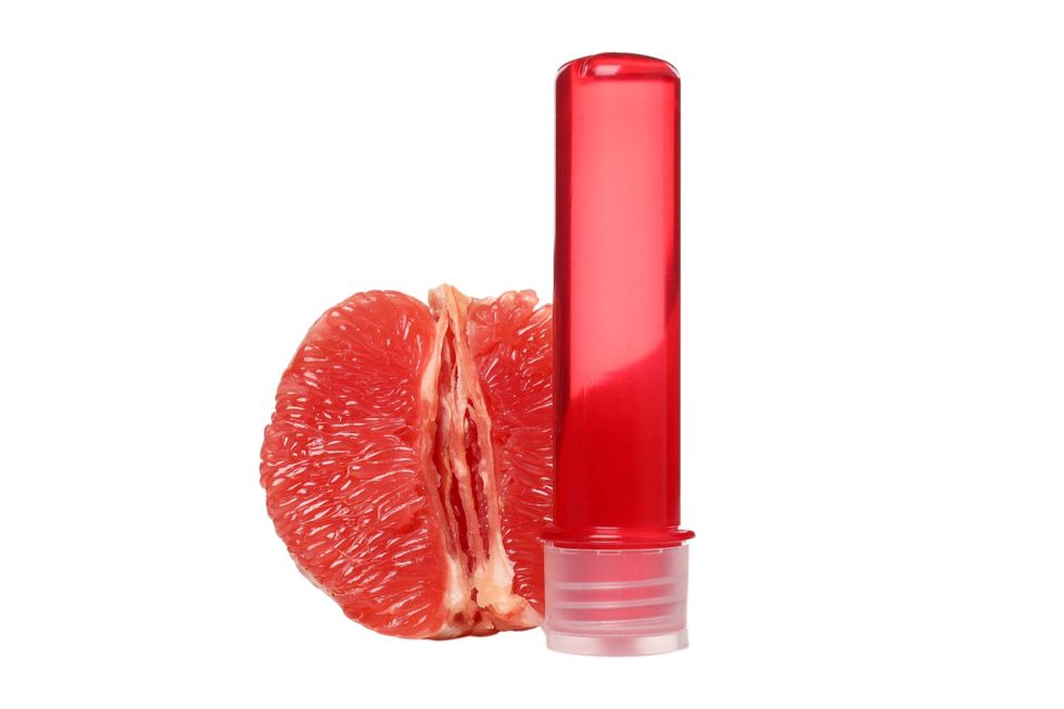 bottle of lube and half of a grape fruit
