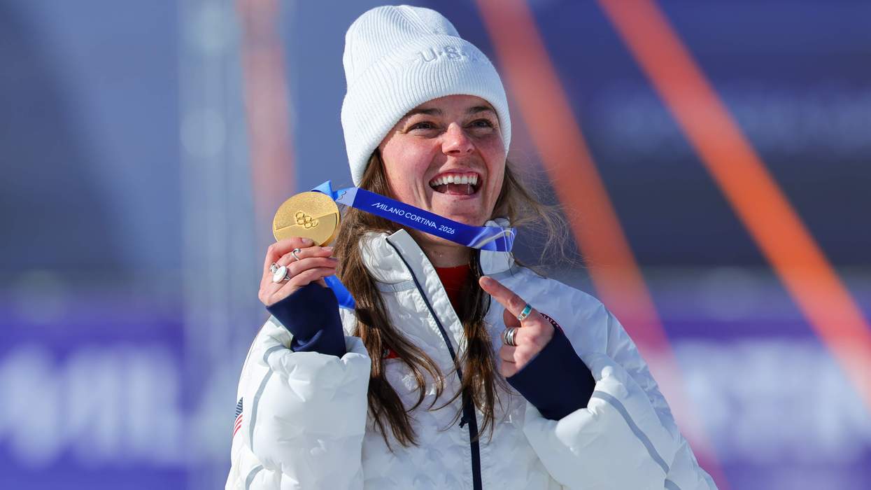 Breezy Johnson holding her Olympic gold medal