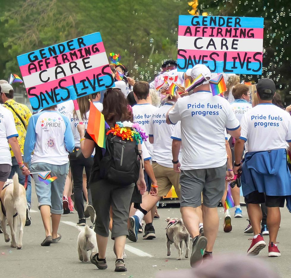 Calgary Alberta Canada transgender march signs gender affirming care saves lives