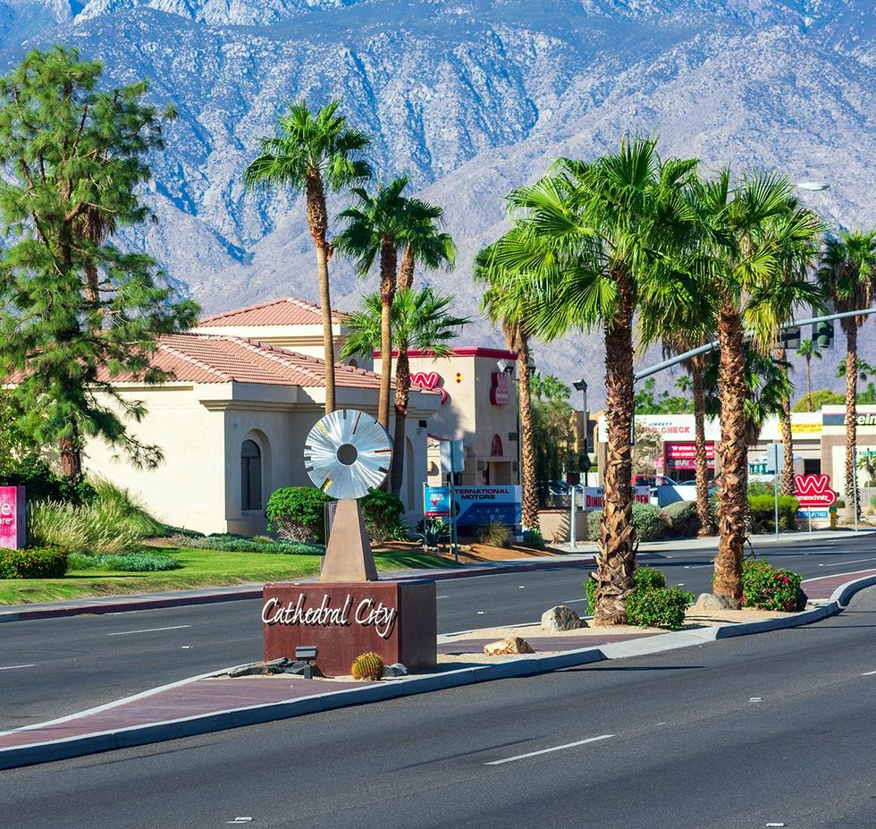 Cathedral City sign at the entrance to the city in Riverside County California public art palm trees and mountains