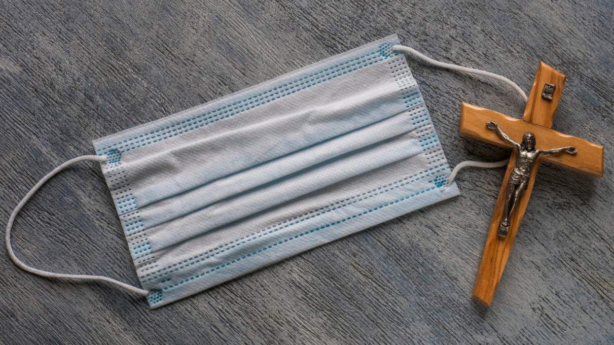 Crucifix with paper face mask