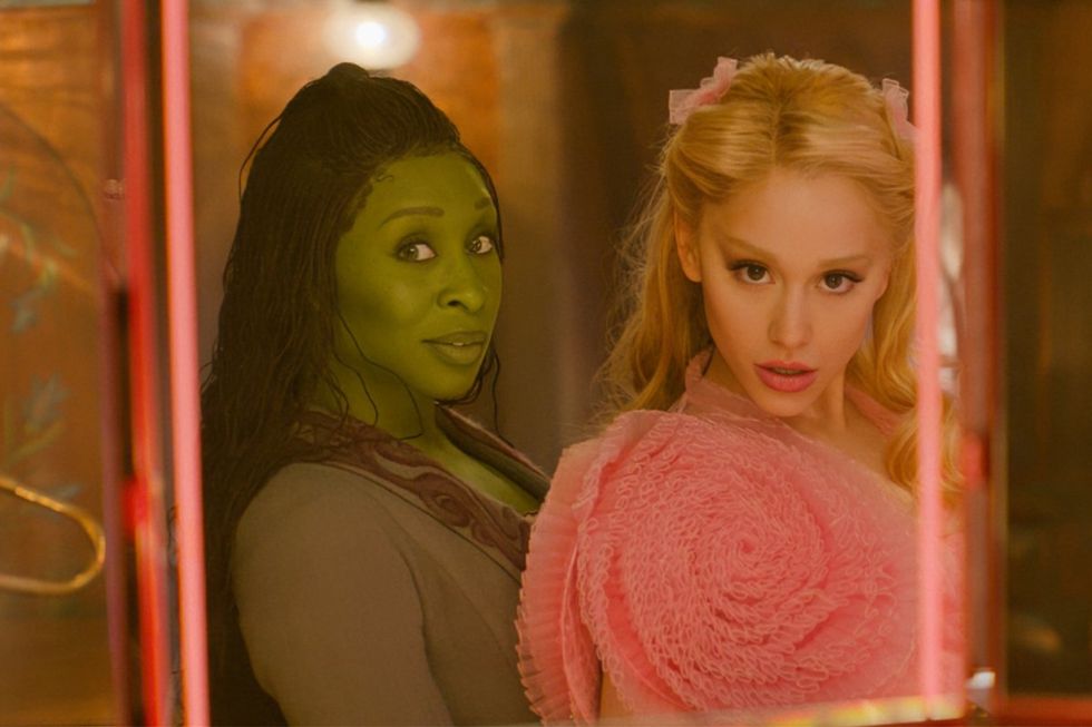 Cynthia Erivo and Ariana Grande posing in front of a mirror in the Wicked movie
