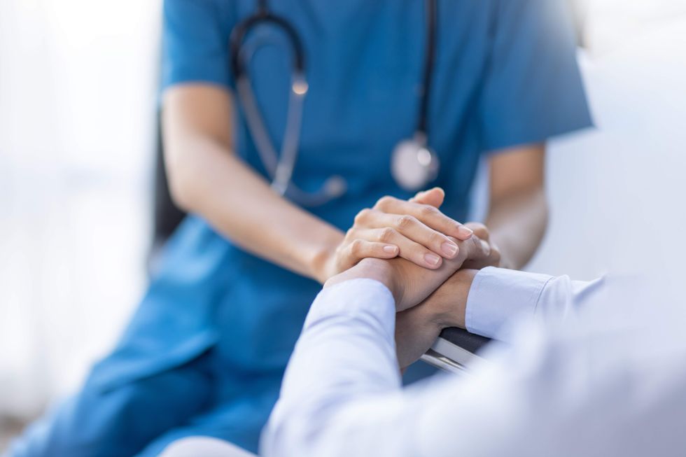 Doctor holding a patient's hand