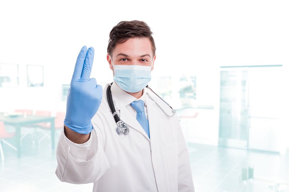 Doctor proctologist wearing white medical uniform being ready for consult