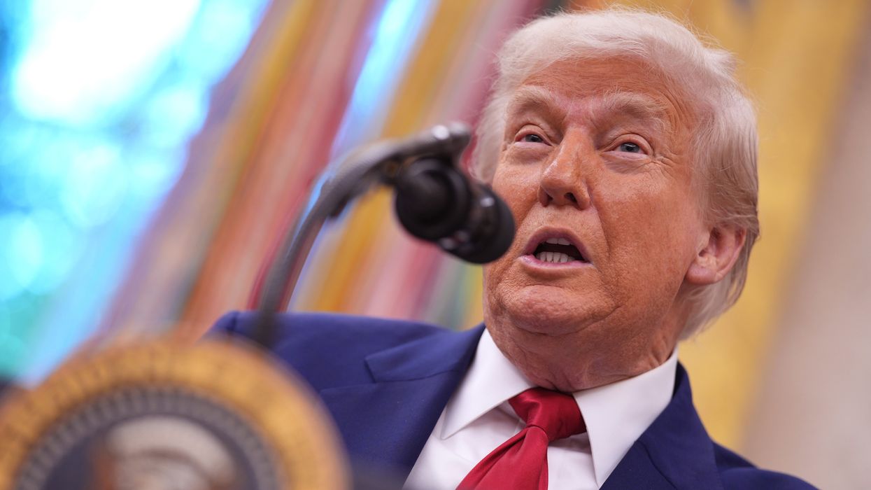 Donald Trump speaking in front of a microphone