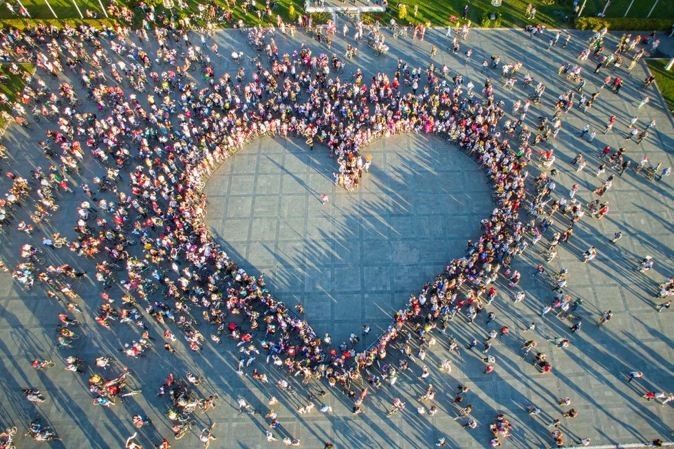 Drone view of women who formed a huge heart shape in the main square of Izmir. International Fancy Women Bike Ride Tour.