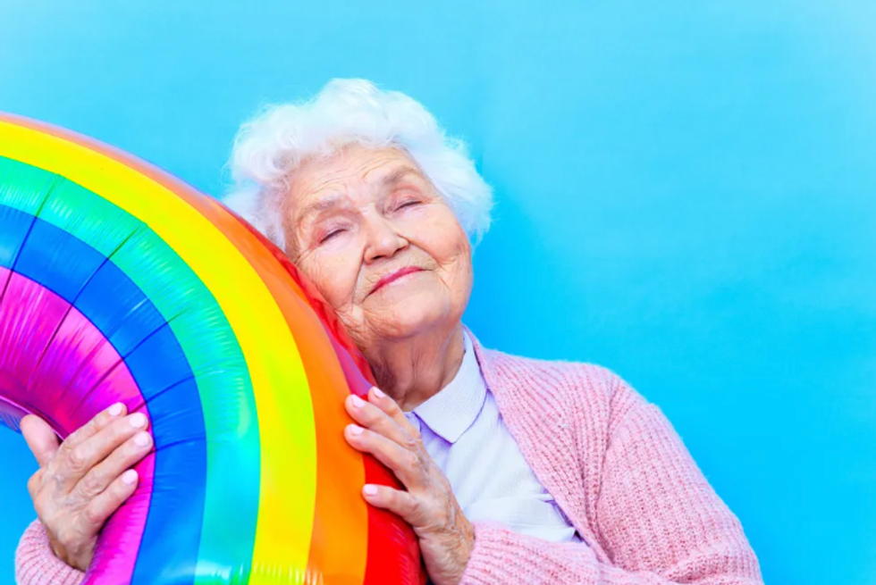 elderly lady holding a rainbow