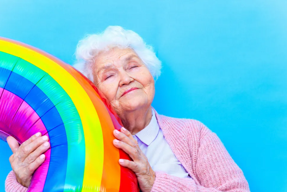 elderly lady holding a rainbow