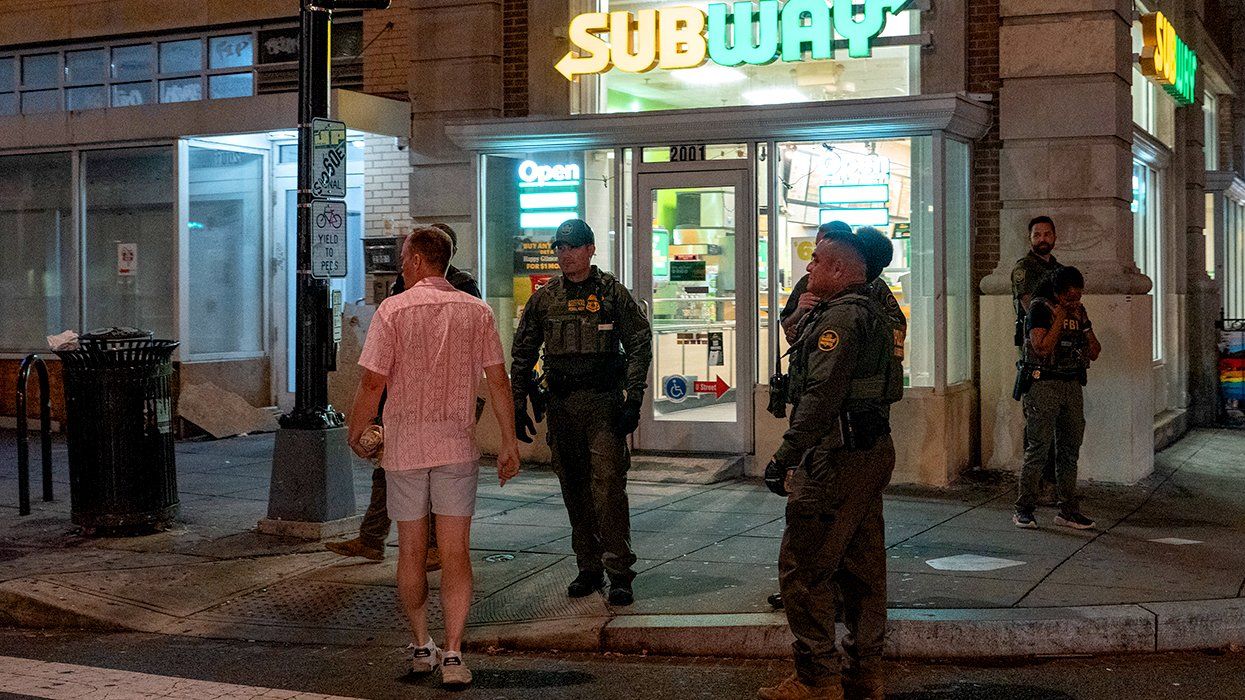 FBI and Border Patrol officers confront a man along the U Street corridor