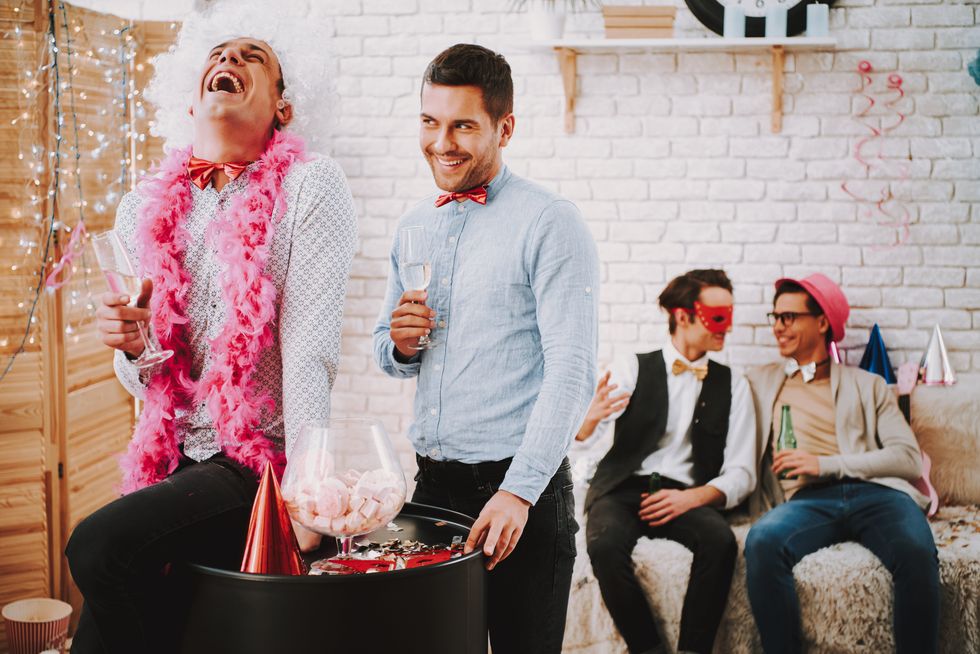 four men dressed up at a party