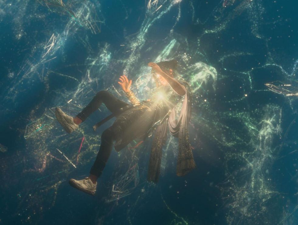 Frey floats surrounded by magical light