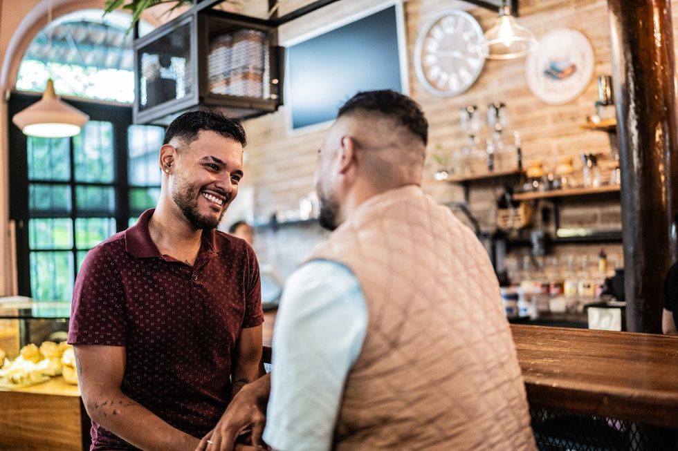 Gay couple talking at a coffee shop