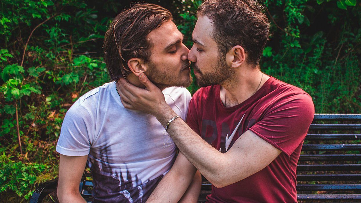 gay cruising concept art two bearded men on park bench about to kiss