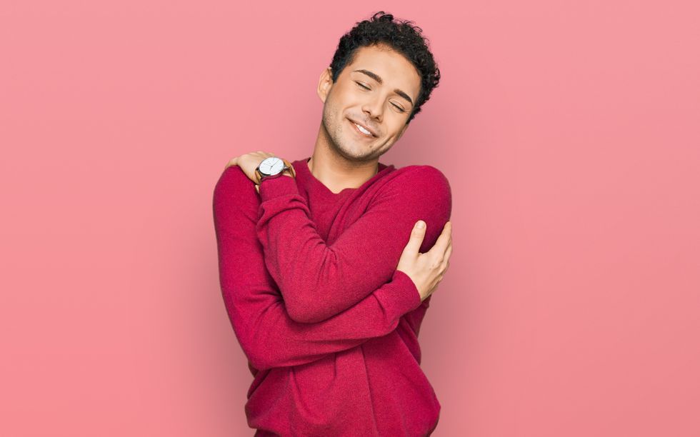 gay man giving himself self love