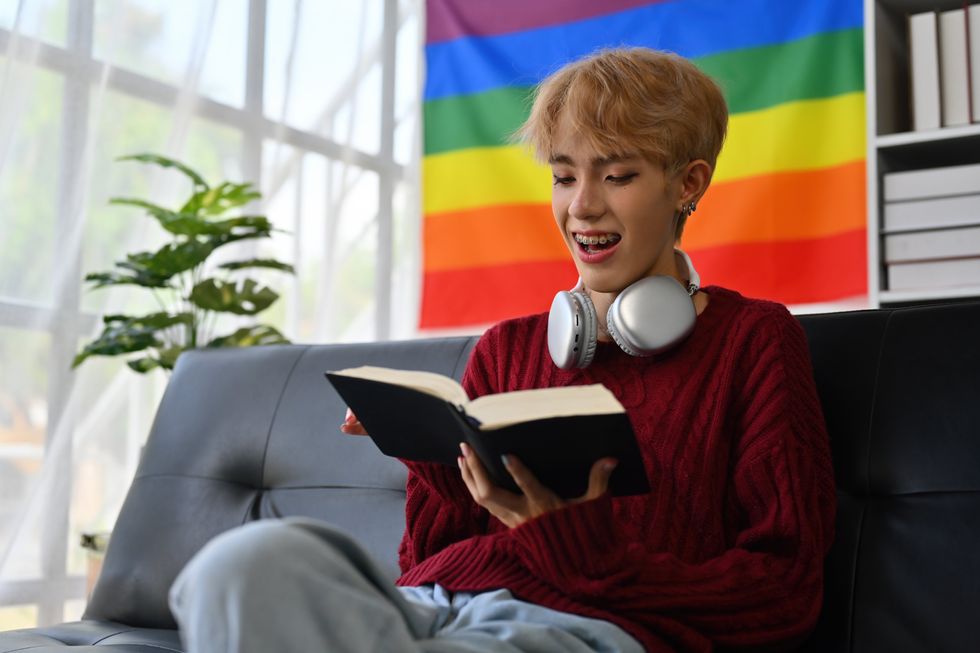 gay man reading and listening to music