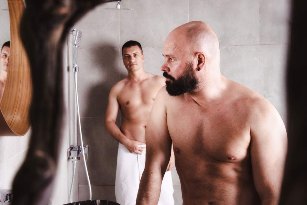 gay men in front of a mirror