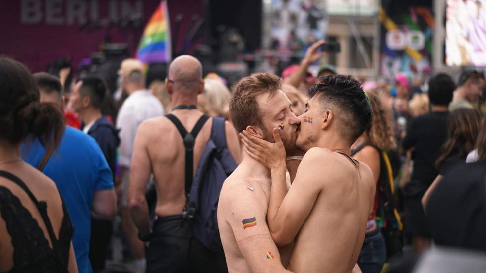 gay men kissing at a pride event