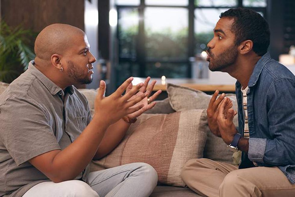 Gay men sitting on a couch arguing