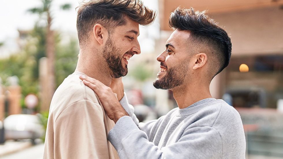 gay men smiling at each other 