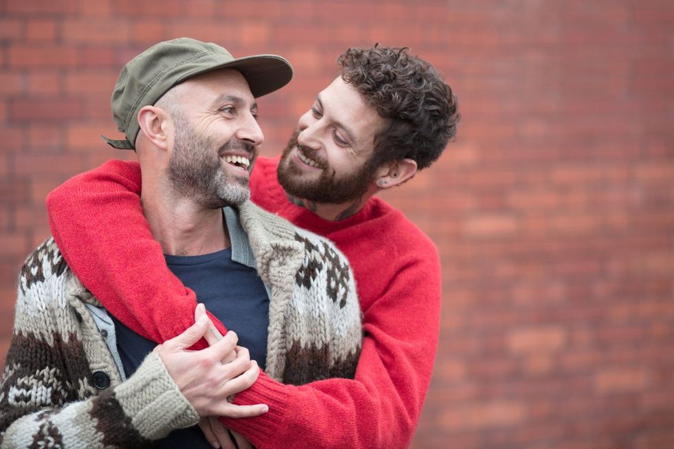 gay men with beards cuddle