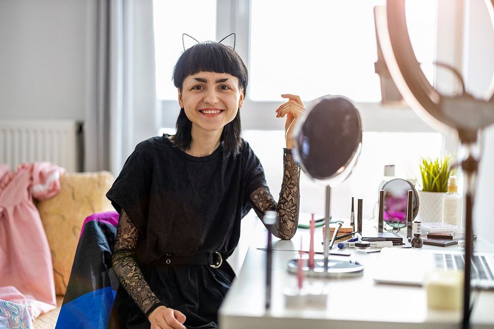 gender non-conforming girl doing makeup