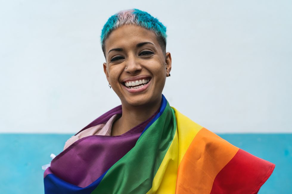 girl smiling with a pride flag