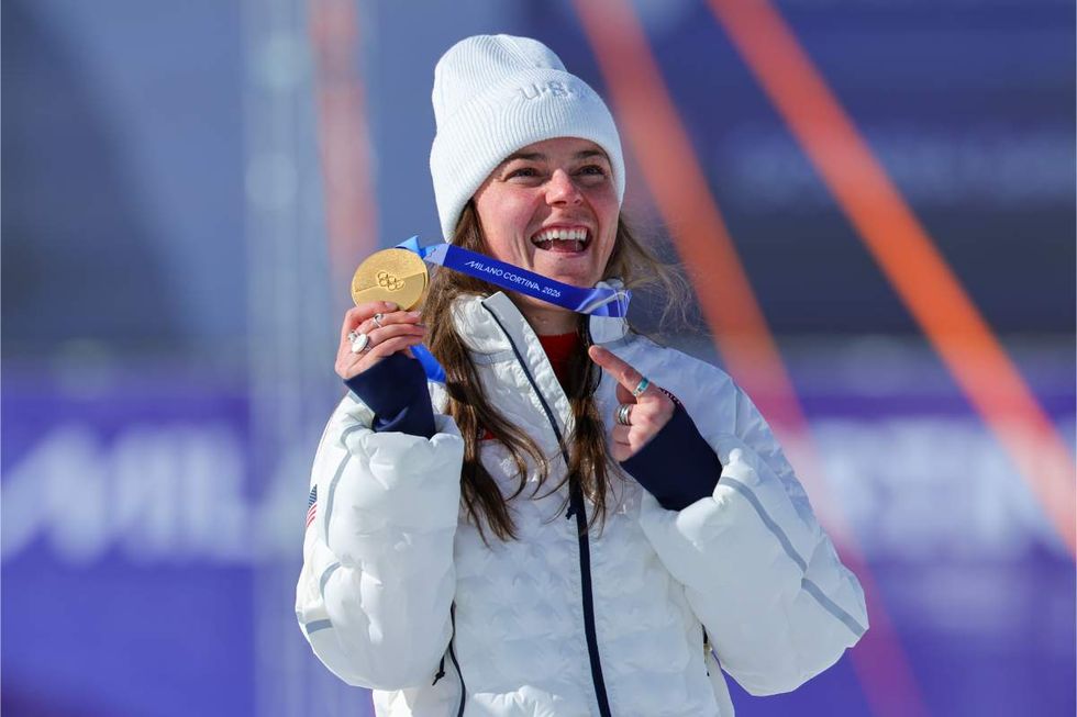 Gold medalist Breezy Johnson of Team United States celebrates on the podium during the medal ceremony for the Women's Alpine Downhill Skiing on day two of the Milano Cortina 2026 Winter Olympics