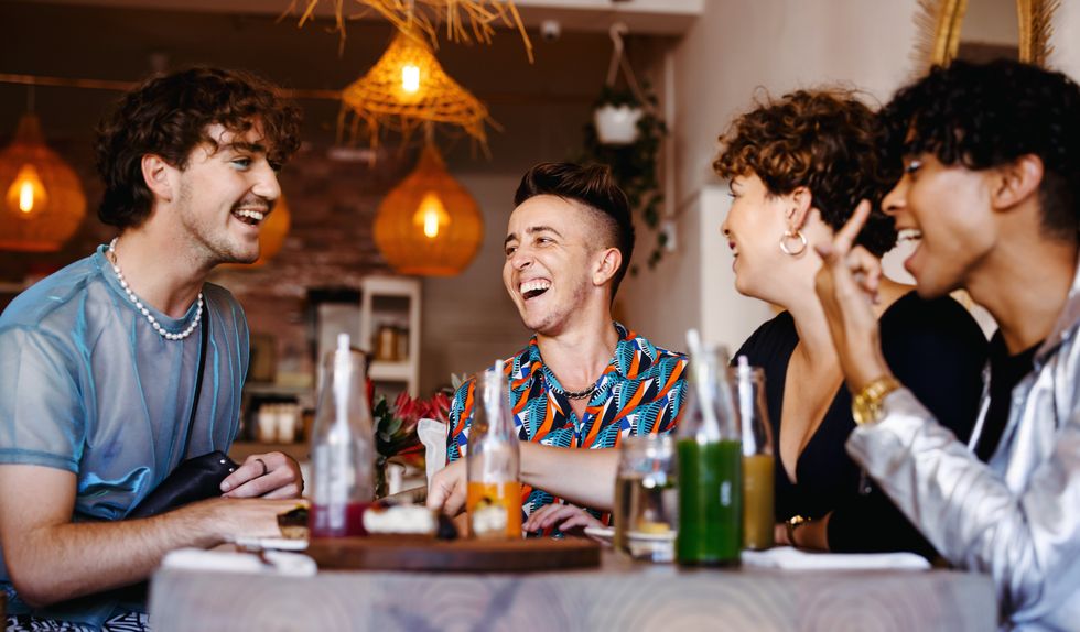 group of friends laughing over a meal