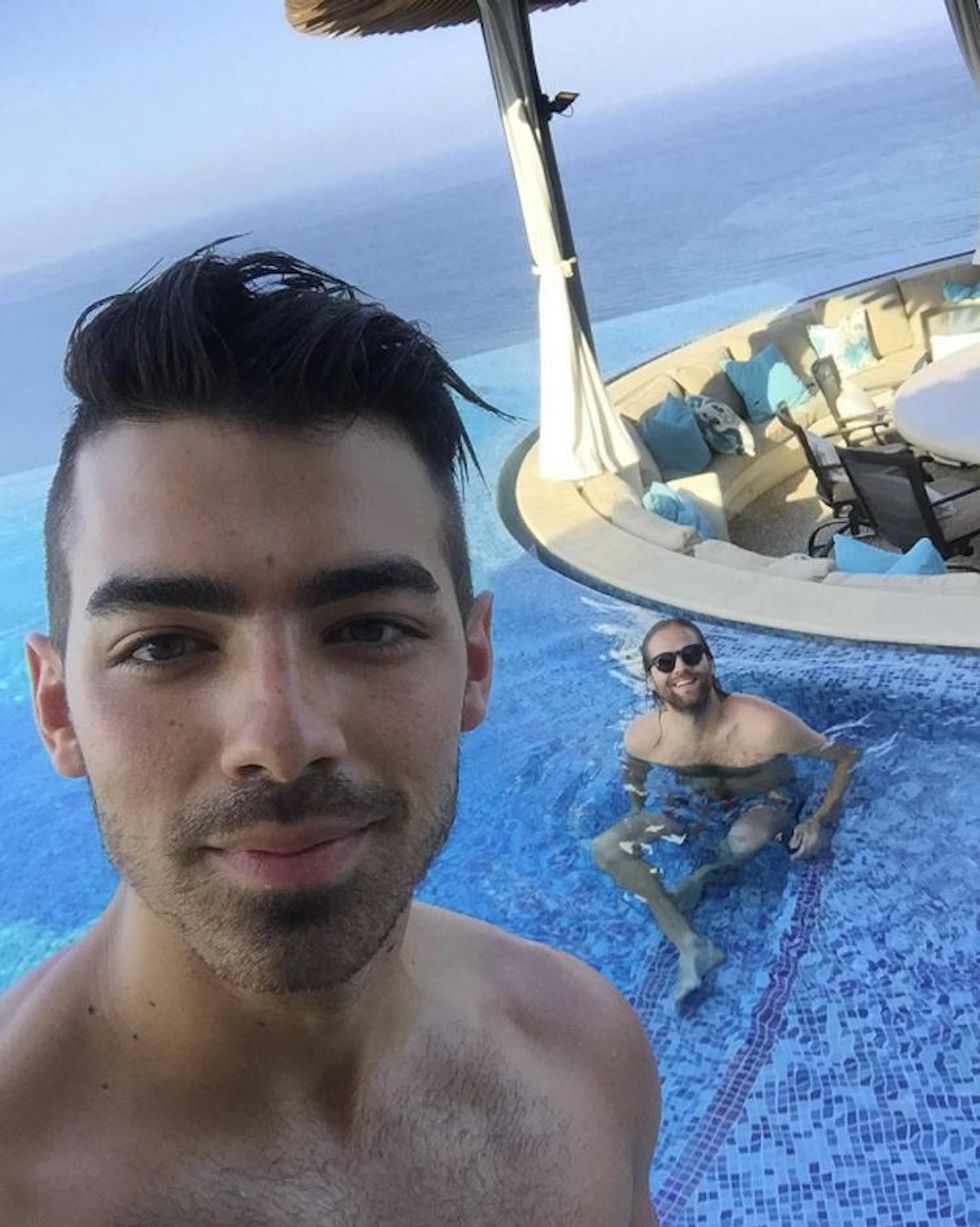 He likes hanging out with friends (poolside and topless, no less).