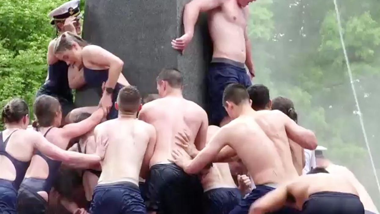 <p>Apparently It's a Naval Academy Tradition to Climb Half Naked Up a Greased Up Pole</p>