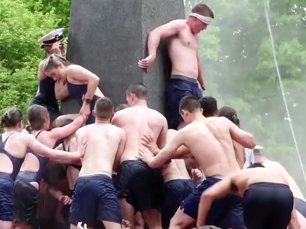 Apparently It's a Naval Academy Tradition to Climb Half Naked Up a Greased Up Pole