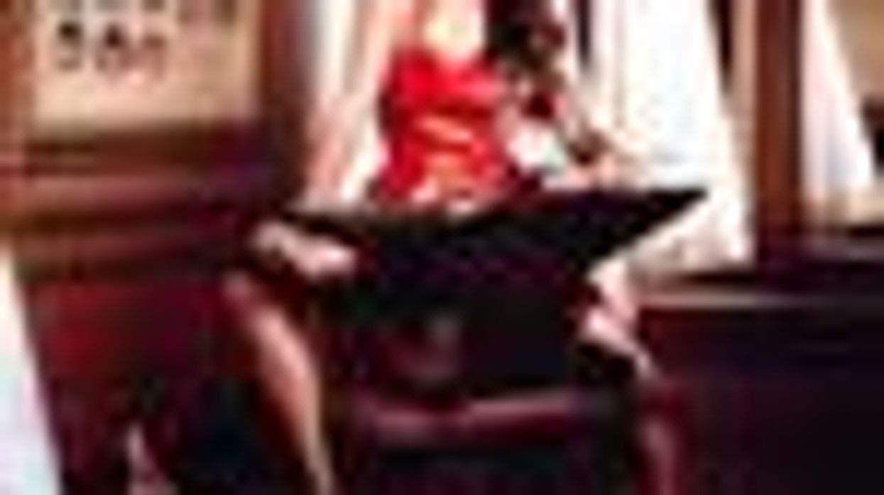 Shot of the Day: Penelope Cruz, an Anvil, Red Romper and Cats for Campari's Calendar