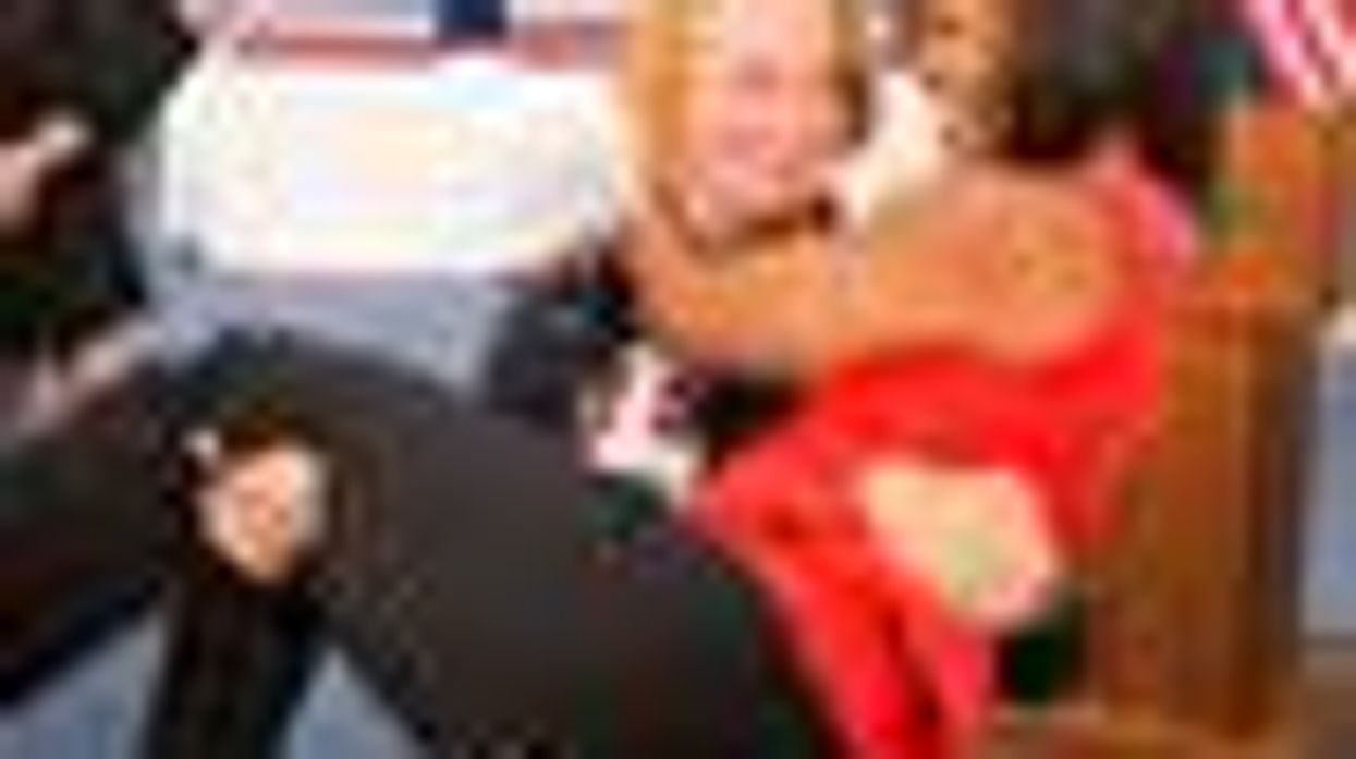 Shot of the Day: Michelle Obama Literally Picked Up by Female Olympic Wrestler