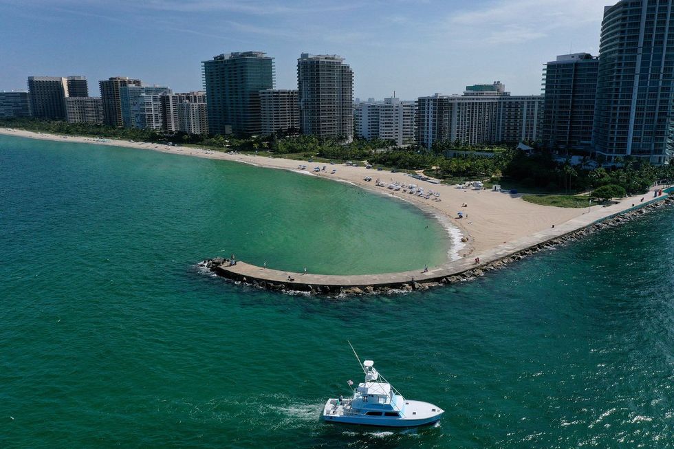 : In an aerial view, a boat arrives at the Haulover inlet from the Atlantic Ocean to on July 11, 2023 in Miami, Florida.